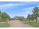 Inviting home with stone accents, a well-maintained lawn, and mature trees, offering great curb appeal at 330 N Rocky Cliff Trl, Franktown, CO 80016