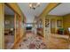 Inviting foyer with hardwood floors, chandelier, and arched doorways at 330 N Rocky Cliff Trl, Franktown, CO 80016