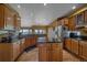Bright kitchen with stainless steel appliances, granite countertops, light wood cabinets, and views of the back yard at 330 N Rocky Cliff Trl, Franktown, CO 80016