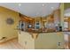 Modern kitchen with stainless steel appliances, granite countertops, and a breakfast bar with seating at 330 N Rocky Cliff Trl, Franktown, CO 80016