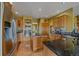 Open kitchen featuring granite countertops, stainless steel appliances, and hardwood flooring at 330 N Rocky Cliff Trl, Franktown, CO 80016