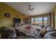 Spacious living room with a stone fireplace, large windows, and comfortable seating at 330 N Rocky Cliff Trl, Franktown, CO 80016