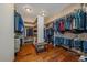 Spacious walk-in closet with custom shelving and hardwood floors, perfect for organizing clothes, shoes, and accessories at 330 N Rocky Cliff Trl, Franktown, CO 80016