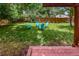 Lush backyard featuring a grassy lawn, wooden fence, and four Adirondack chairs at 3071 S Jasmine St, Denver, CO 80222