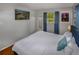 Bedroom with a view of the yard, a wall mounted TV, and a tall mirror at 3071 S Jasmine St, Denver, CO 80222