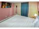 Bedroom featuring pink walls, floral wallpaper, and a wall mounted TV at 3071 S Jasmine St, Denver, CO 80222