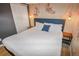 Bedroom featuring floral wallpaper, a king bed with a blue tufted headboard at 3071 S Jasmine St, Denver, CO 80222