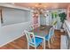 Dining room with hardwood floors, a contemporary chandelier, and view of the backyard at 3071 S Jasmine St, Denver, CO 80222