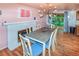 Stylish dining room with a modern chandelier, fireplace, and sliding door to the yard at 3071 S Jasmine St, Denver, CO 80222