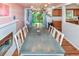 Bright dining area featuring a modern chandelier, fireplace, and view of the backyard at 3071 S Jasmine St, Denver, CO 80222
