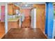 Traditional kitchen with wood cabinets and floors, with an open layout and eat-in dining area at 3071 S Jasmine St, Denver, CO 80222