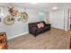 Basement living room with wood-look tile flooring, sofa, and closet at 3071 S Jasmine St, Denver, CO 80222
