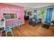 Bright living area boasts hardwood floors and a vanity space with seating at 3071 S Jasmine St, Denver, CO 80222
