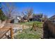 Large, fenced backyard with grass, mature trees, garden area, and storage shed at 21710 Silver Meadow Ln, Parker, CO 80138