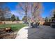 Spacious backyard featuring a patio with table and chairs, and a fire pit for outdoor relaxation at 21710 Silver Meadow Ln, Parker, CO 80138