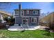 Back exterior featuring a spacious patio, furniture set and landscaped yard at 21710 Silver Meadow Ln, Parker, CO 80138