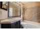 Bathroom features a shower-tub combination with tile backsplash and dark vanity at 21710 Silver Meadow Ln, Parker, CO 80138