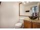 Stylish half-bathroom featuring elegant vanity, granite counters, and decorative mirror at 21710 Silver Meadow Ln, Parker, CO 80138