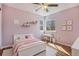 Bedroom with pink walls and a desk near the bright window at 21710 Silver Meadow Ln, Parker, CO 80138