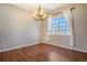 Bright dining room with hardwood floors, chandelier, and a large window with sheer curtains at 21710 Silver Meadow Ln, Parker, CO 80138