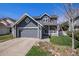Charming two-story home with a front porch, well-maintained lawn, and a two-car garage at 21710 Silver Meadow Ln, Parker, CO 80138