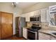 Well-equipped kitchen featuring modern appliances, granite countertops, and ample cabinet space at 21710 Silver Meadow Ln, Parker, CO 80138