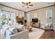 Comfortable living room with fireplace, ceiling fan, hardwood floors and natural lighting at 21710 Silver Meadow Ln, Parker, CO 80138