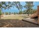 Large backyard with a retaining wall, green space, trees, wooden fence, and access to the house at 37677 Sable Ridge Rd, Elizabeth, CO 80107