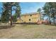 Backyard with a bright yellow home exterior, wooden deck with stairs, and plenty of green space at 37677 Sable Ridge Rd, Elizabeth, CO 80107