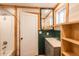 This bathroom features a sink, a shower/tub, wooden walls, and mixed materials at 37677 Sable Ridge Rd, Elizabeth, CO 80107