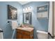 Stylish bathroom with blue walls, vanity and decorative mirror at 37677 Sable Ridge Rd, Elizabeth, CO 80107