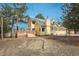 A welcoming yellow home with a deck, two-car garage, and solar panels is nestled between mature pine trees at 37677 Sable Ridge Rd, Elizabeth, CO 80107