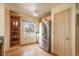 Bright kitchen featuring stainless steel refrigerator, shelving and light wood cabinets at 37677 Sable Ridge Rd, Elizabeth, CO 80107