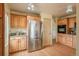 Updated kitchen featuring stainless steel refrigerator, wood cabinets, and granite counters at 37677 Sable Ridge Rd, Elizabeth, CO 80107
