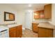 Laundry area and half bath with tile floors, wooden cabinets, vanity mirror, and washer/dryer at 37677 Sable Ridge Rd, Elizabeth, CO 80107