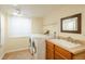 Laundry area with tile floors, wooden cabinets, vanity mirror, and newer model washer and dryer at 37677 Sable Ridge Rd, Elizabeth, CO 80107