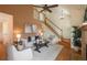 Inviting living area with vaulted ceiling, a fireplace, a staircase to an open loft, and neutral decor at 37677 Sable Ridge Rd, Elizabeth, CO 80107