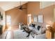 Vaulted living room featuring an open staircase, hardwood floors, a fireplace, large windows, and a neutral color palette at 37677 Sable Ridge Rd, Elizabeth, CO 80107