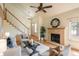 Inviting living room featuring high ceilings, a ceiling fan, and a stone fireplace at 37677 Sable Ridge Rd, Elizabeth, CO 80107