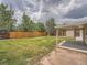 Large backyard with a well-maintained lawn and tall wooden fence offers plenty of room for outdoor enjoyment at 1245 Troy St, Aurora, CO 80011
