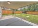 Covered patio offers an outdoor space to enjoy the expansive, green backyard with a wood fence for privacy at 1245 Troy St, Aurora, CO 80011