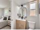 Stylish bathroom featuring an ornate wood vanity, modern fixtures, and an arched mirror at 1245 Troy St, Aurora, CO 80011