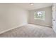 Empty bedroom featuring neutral paint, carpet floors, and a window providing natural light at 1245 Troy St, Aurora, CO 80011