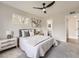 Comfortable bedroom featuring a ceiling fan, a window with natural light, and neutral decor at 1245 Troy St, Aurora, CO 80011