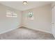 Empty bedroom featuring neutral paint, carpet floors, and a window providing natural light at 1245 Troy St, Aurora, CO 80011
