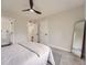 Spacious bedroom featuring neutral paint, a ceiling fan, and a large mirror at 1245 Troy St, Aurora, CO 80011