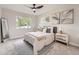 Comfortable bedroom featuring a ceiling fan, a window with natural light, and neutral decor at 1245 Troy St, Aurora, CO 80011