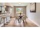 Cozy dining area with stylish furniture, a decorative accent wall and lots of natural light at 1245 Troy St, Aurora, CO 80011