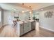 Modern kitchen with a white countertop island, stainless steel appliances, and an adjacent dining area at 1245 Troy St, Aurora, CO 80011