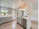 Well-designed kitchen with gray cabinetry, stainless steel appliances, and a view into the dining area at 1245 Troy St, Aurora, CO 80011